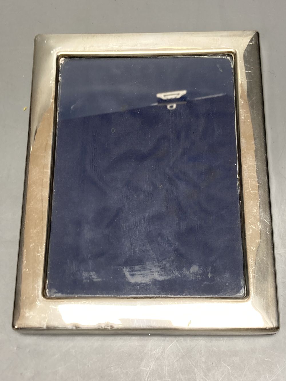 An Edwardian silver mounted photograph frame, Birmingham, 1906, 22.2cm(a.f.) and two others.